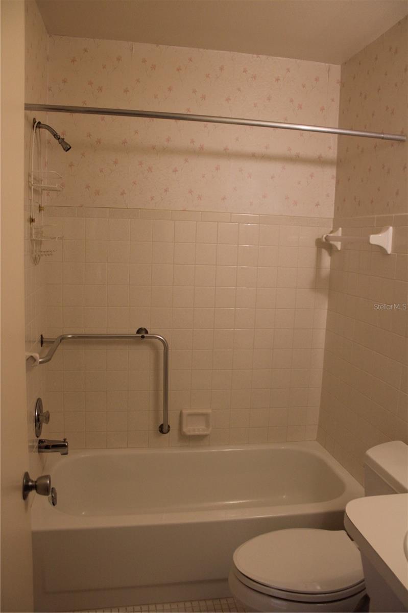 Hall Bath with shower in tub.  Both baths are light neutral colors