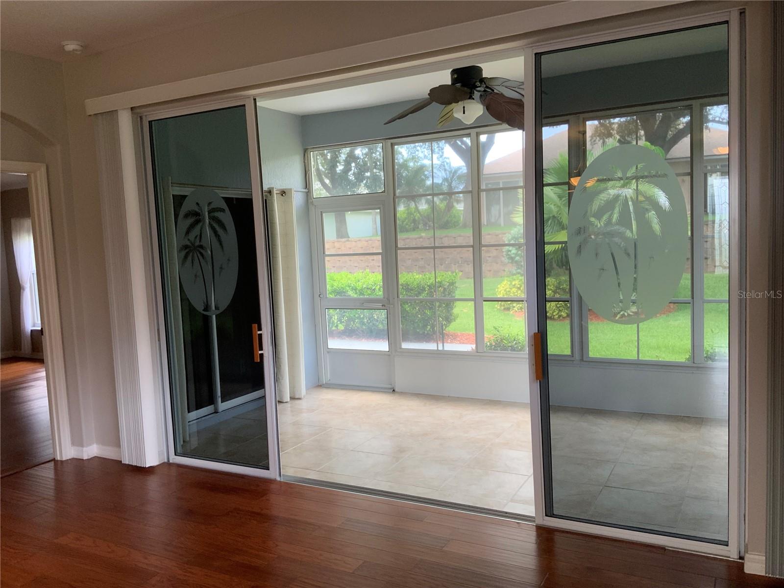 Lanai with tiled floor, screens, and vinyl windows.