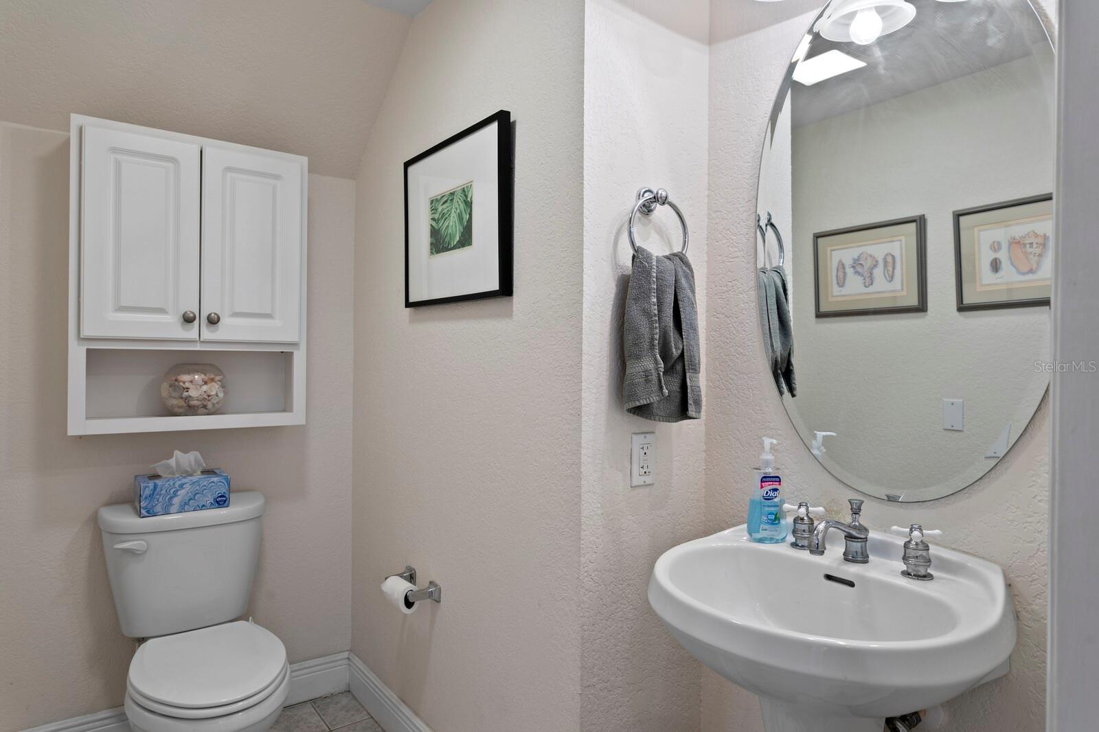 A half bath is tucked away under the stairs for visitors.