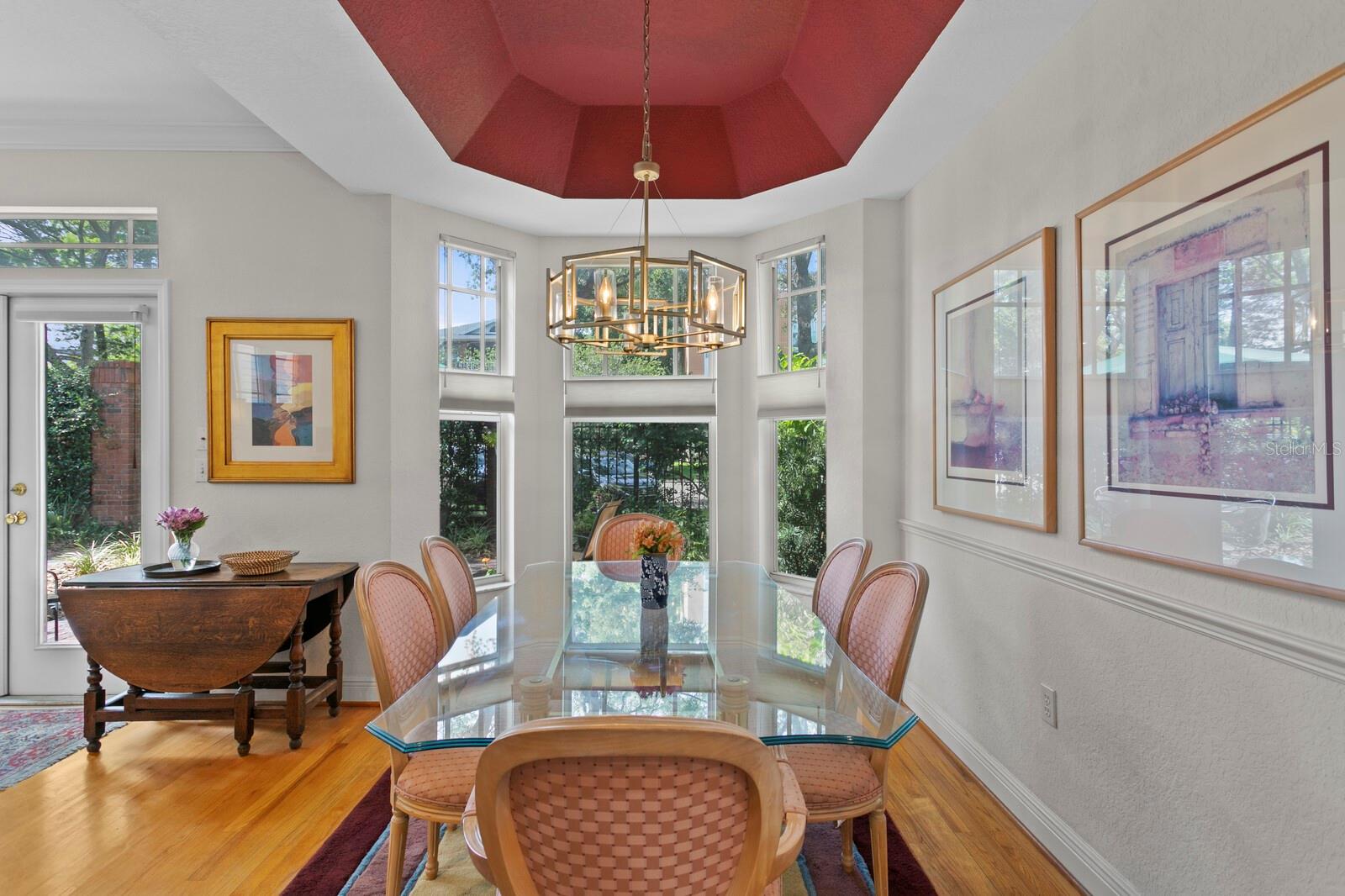 A separate dining space features a bay window overlooking the patio.