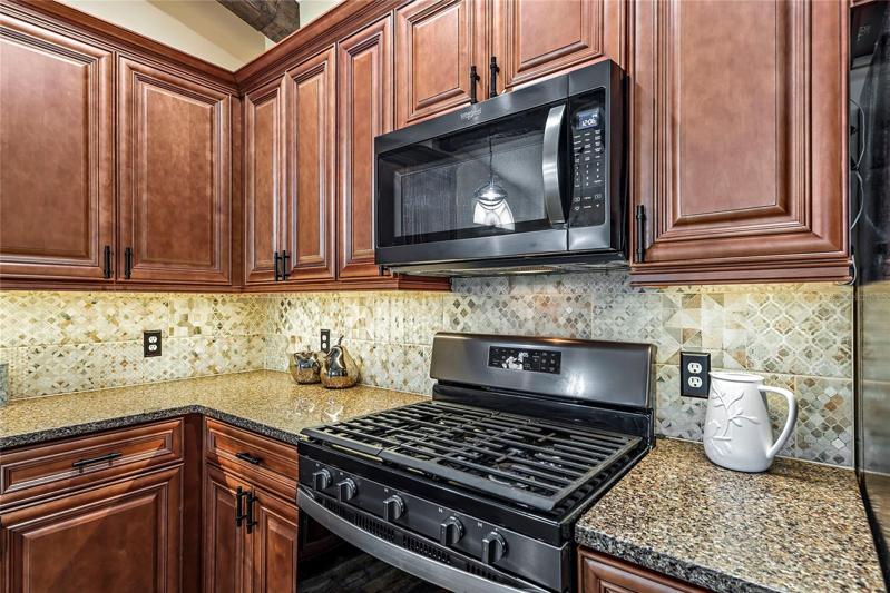 kitchen with gas stove, back splash