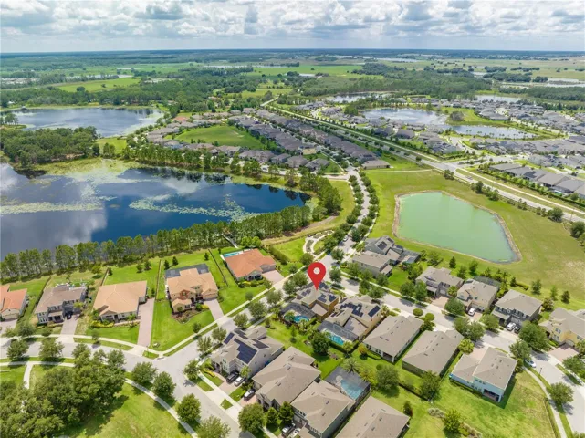 Aerial view of house nearby pond & lake