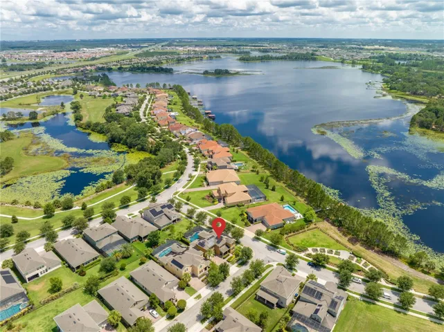 Aerial view of house & nearby lake