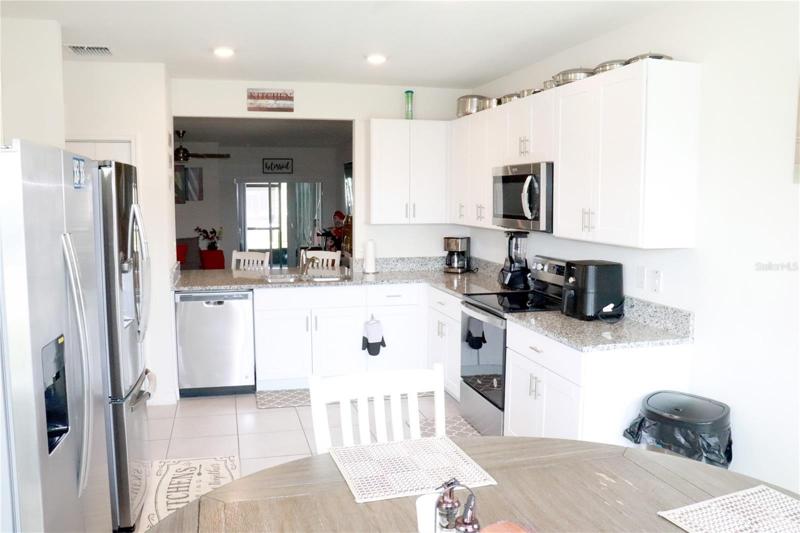 Kitchen with wood cabinets, Granite counter tops and stainless steel appliances.