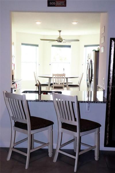Kitchen bar with space that gives you a chance to be connected with your family in the living room.