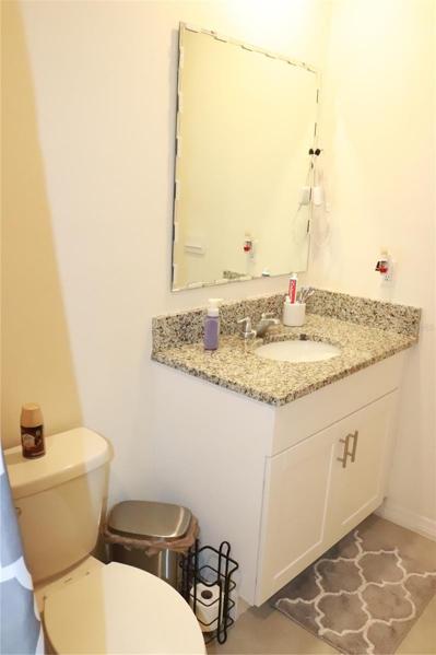 Second bathroom with wood cabinets and granite counter tops