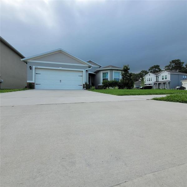 Front showing driveway and 2 car garage