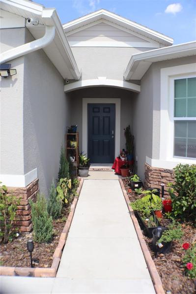 front door with lots of space for your plants and gutters that prevent the entrance from getting excess rain water on the side garden.