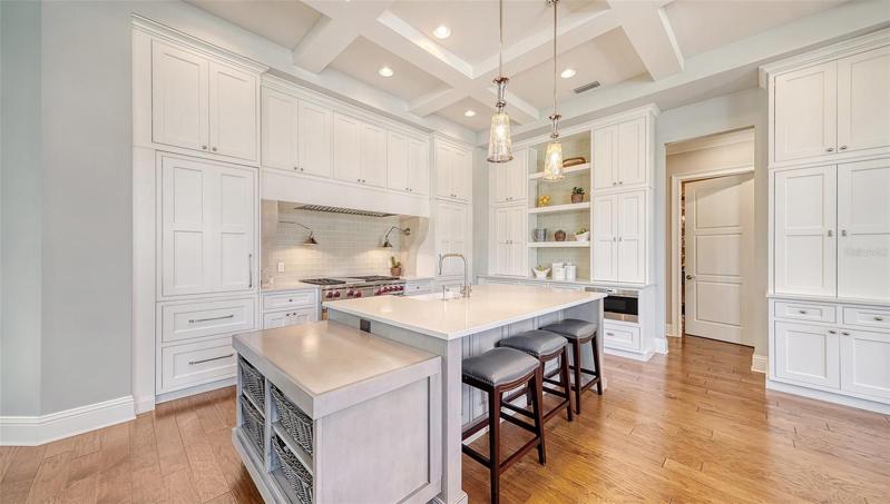 kitchen with separate refrigerator and freezer built to match expansive cabinetry