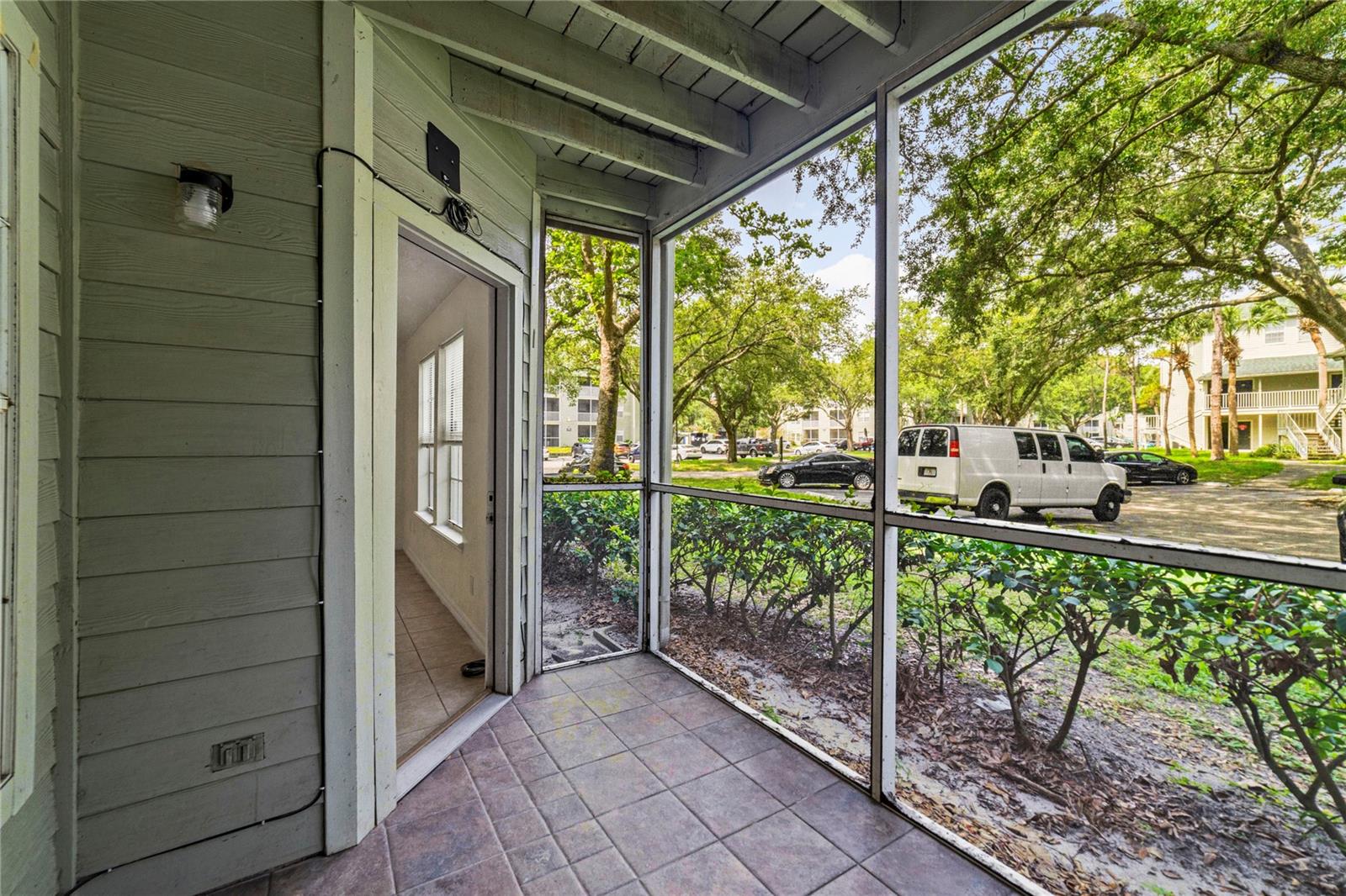 The SCREENED LANAI is a quiet space to start and end your day with views of the beautiful mature trees that provide the backdrop for this lovely community!