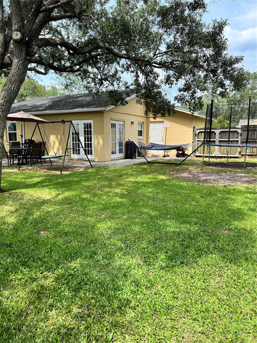 View towards the home.  Swing and hammock don't convey.  Trampoline can be left or removed.