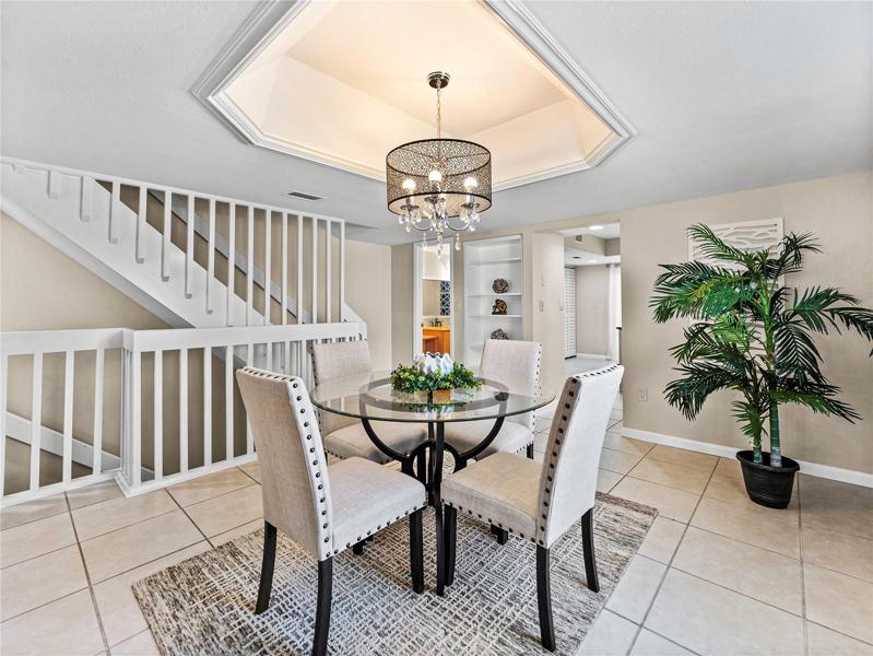 The dining room area has a decorative ceiling touch that adds elegance and defines the space very well.