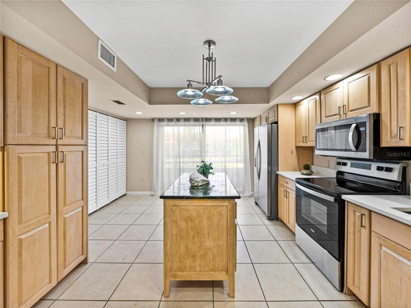 The island with granite countertop was an attractive and very functional later addition, adding drawer and countertop space.
