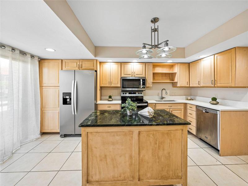 There is plenty of lighting provided via the flush ceiling downlighters and the attractive chandelier!