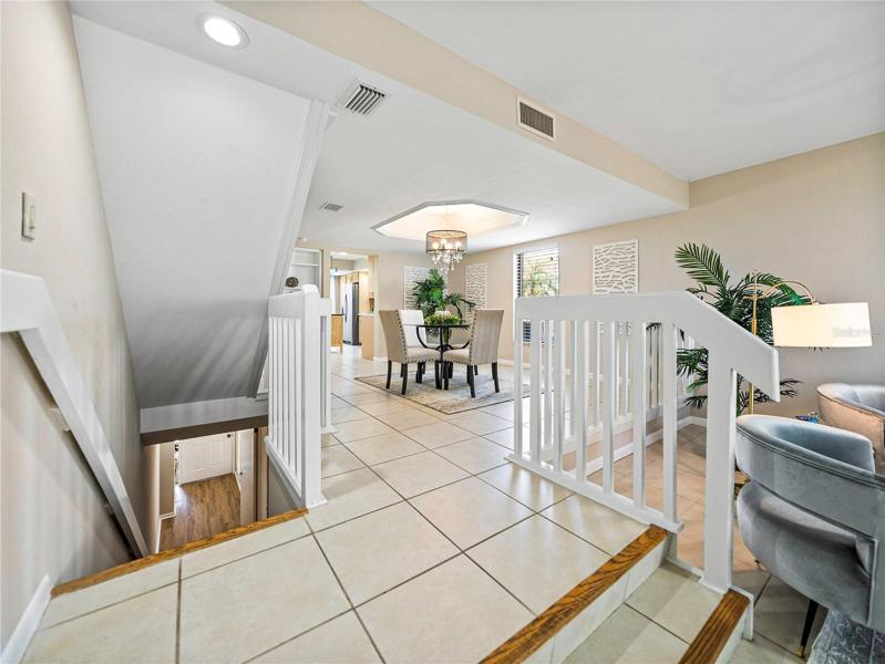 Let's go from the living/dining room areas downstairs toward the front door and the bonus rooms!