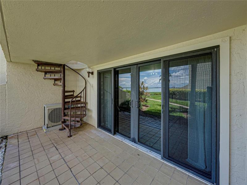 The exterior patio is covered - so good rain or shine. It accesses the 2nd floor via the spiral staircase.