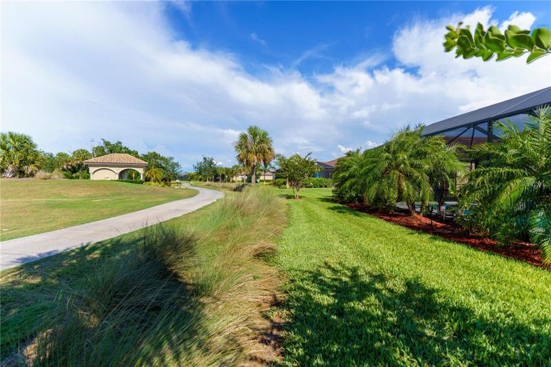 View from back yard shows some of the mature, professional  landscaping added by owners