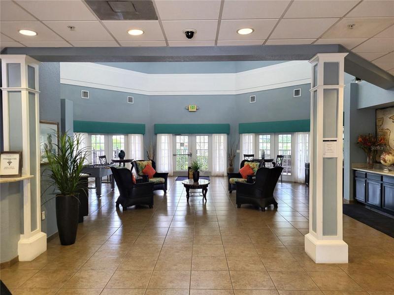 Clubhouse Lounge, with coffee bar and Business Center, opening to pool.  Front desk manned 24 hrs