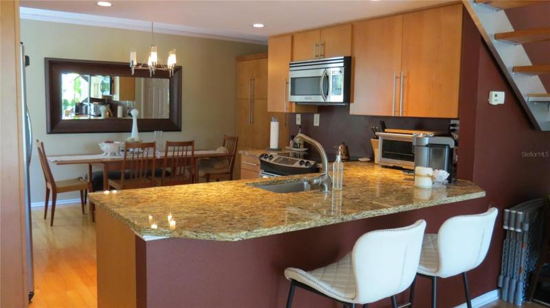 Kitchen with granite, SS appliances, opens up to LR