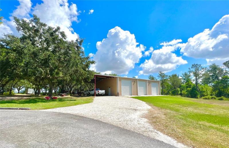 oversized 3 bay garage building plus carport