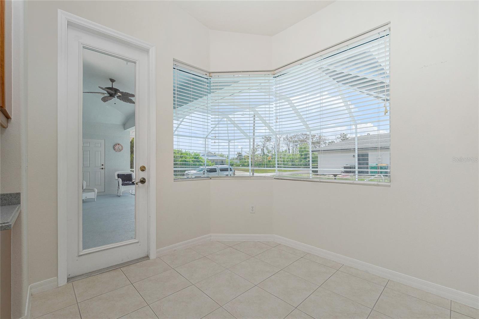 Breakfast nook has an aquarium window overlooking the pool