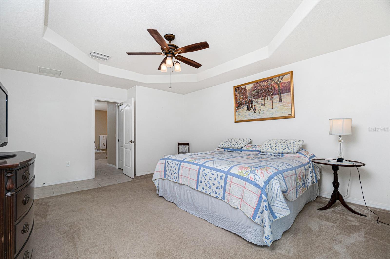 Tray ceiling and ceiling fan in the master bedroom
