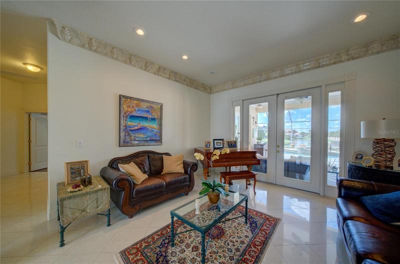 Formal living room with access to the pool