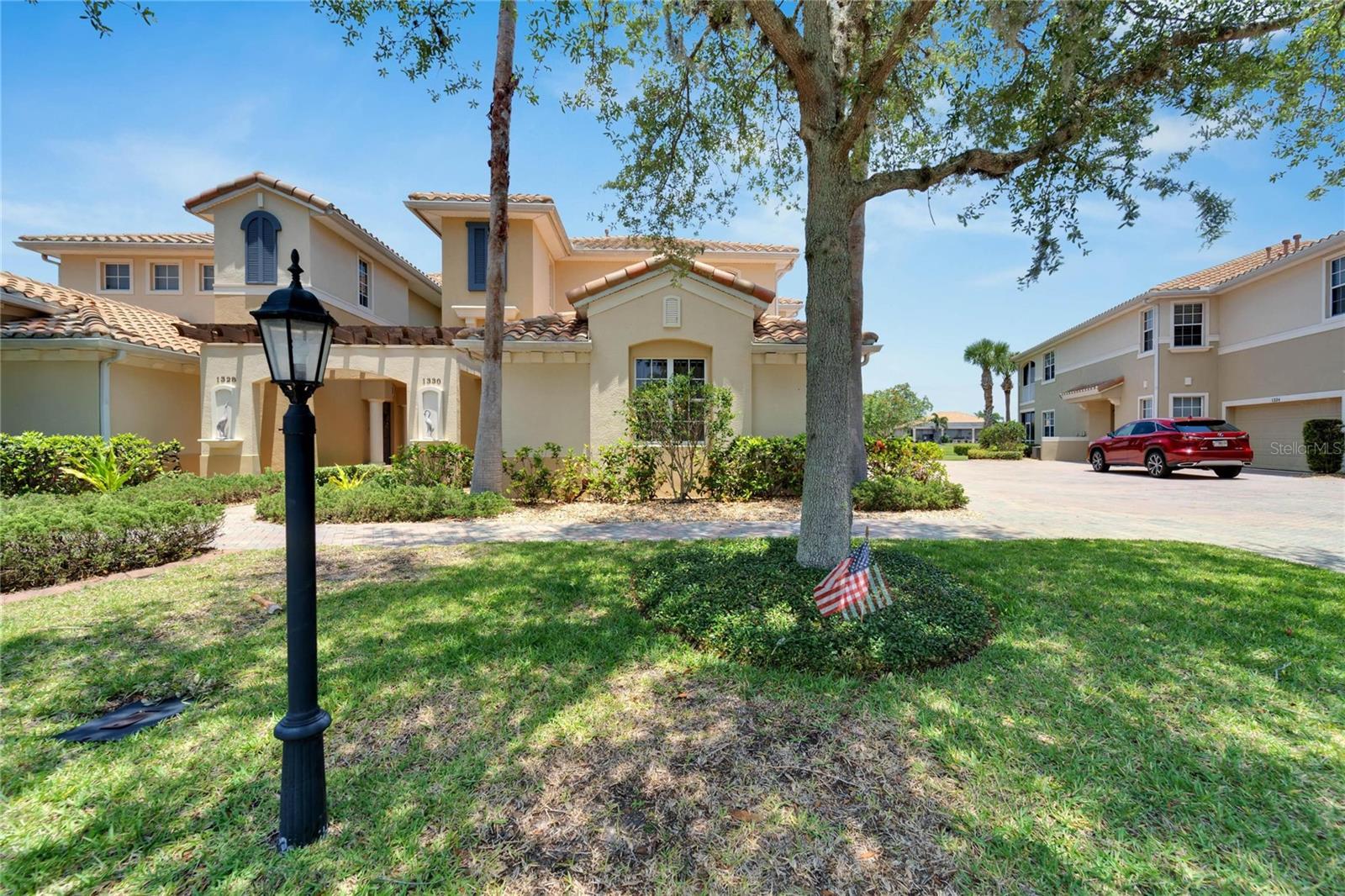 This view is of the front entrance of the main building which includes both the upstairs and downstairs luxury villas and spacious front lawn area. Enjoy a morning stroll with neighbors around the community.