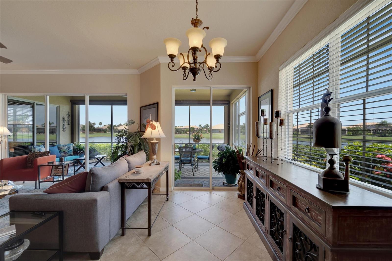 Dual sliding and triple sliding doors open into the covered screened Lanai with private sun shades.