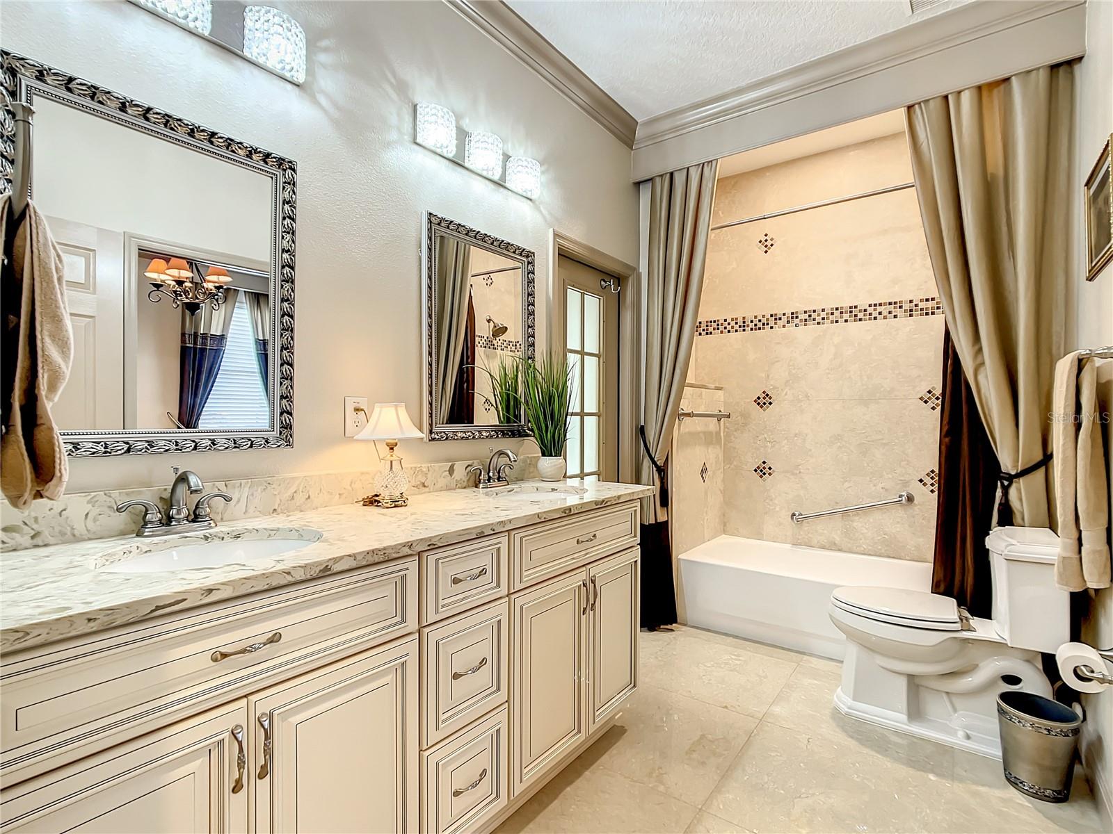 THIS BEAUTIFULLY UPDATED 3RD BATHROOM OPENS TO  BEDROOM 3 AND FLORIDA ROOM
