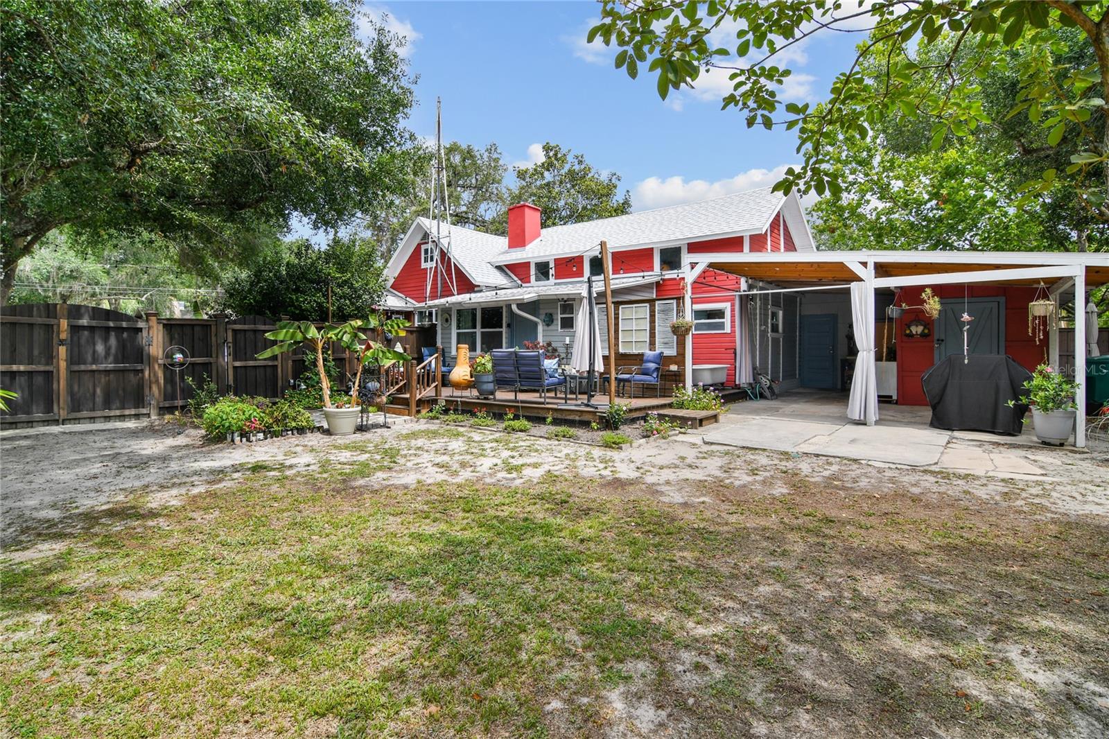 Large Back Yard Fenced with a 6' Fence, Deck, carport and added outdoor shower