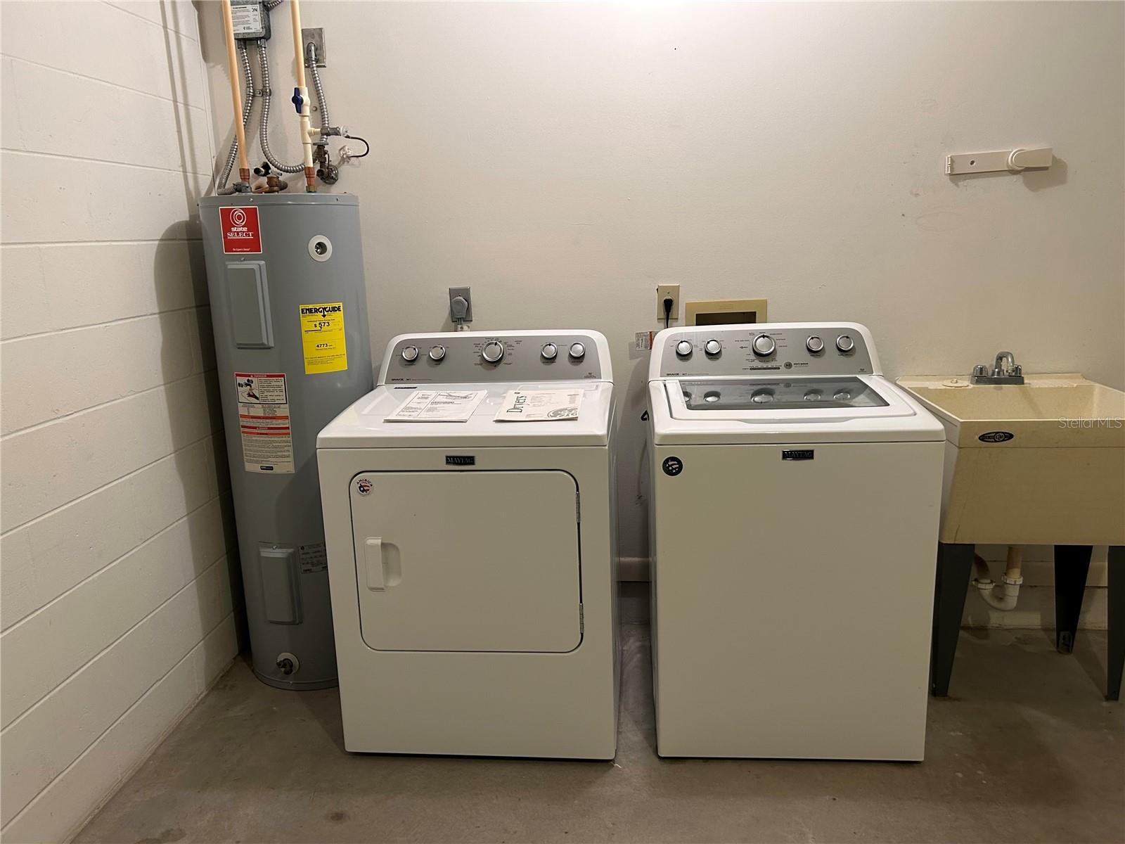 Washer and dryer and utility sink in garage