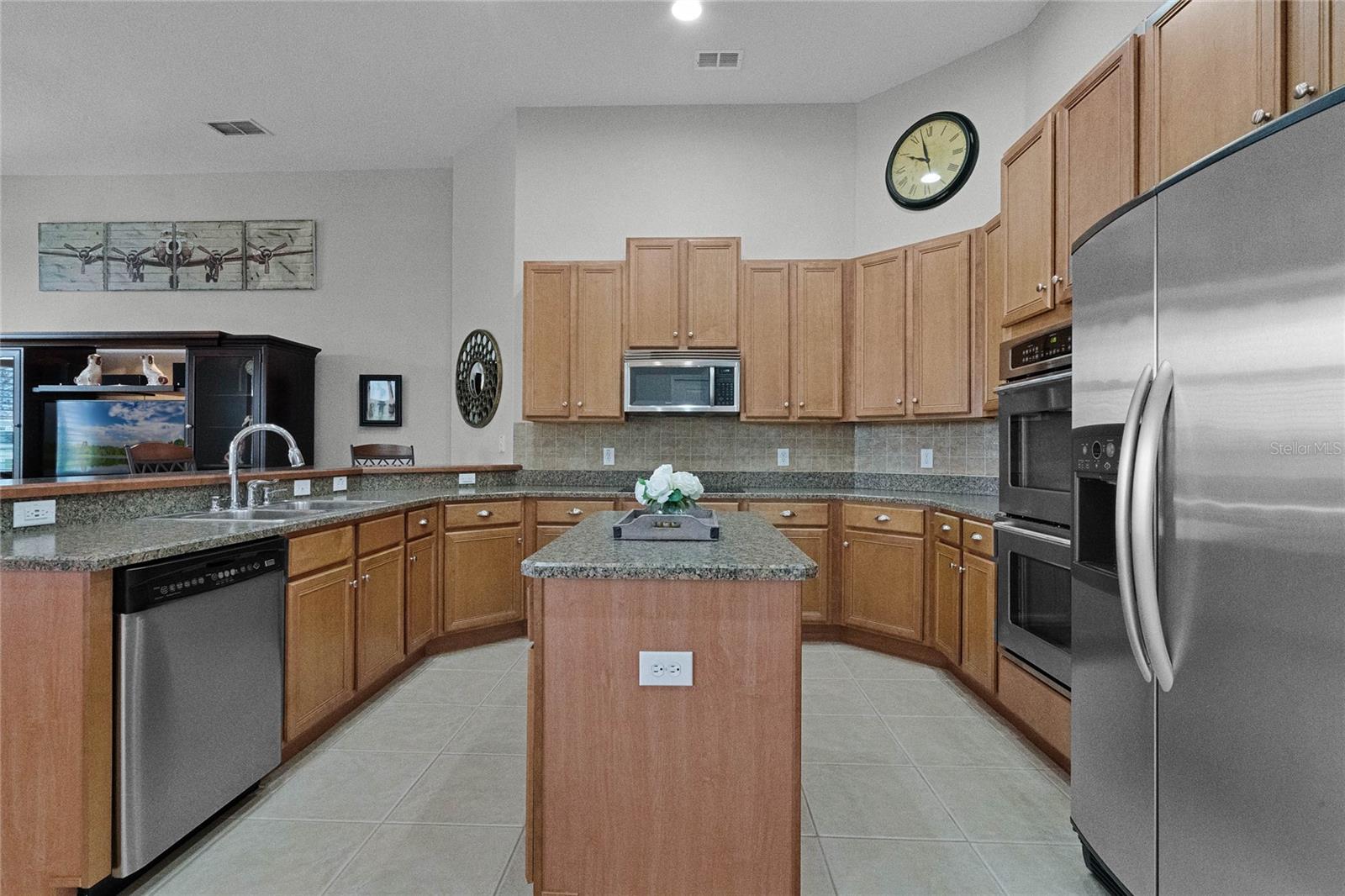 Ample space between island and perimeter cabinets.