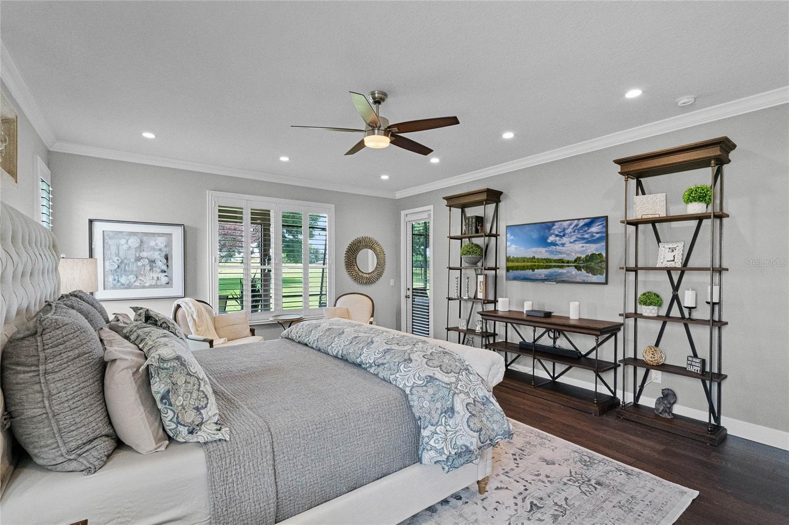 PRIMARY BEDROOM W/CROWN MOULDING, PRIVATE DOOR TO COVERED LANAI