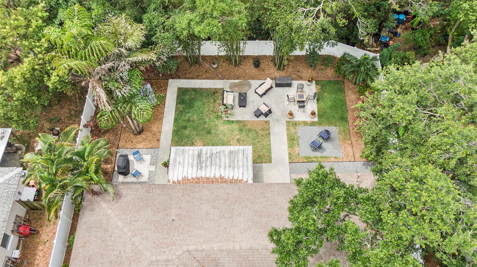Vinyl fenced yard for privacy with mature trees