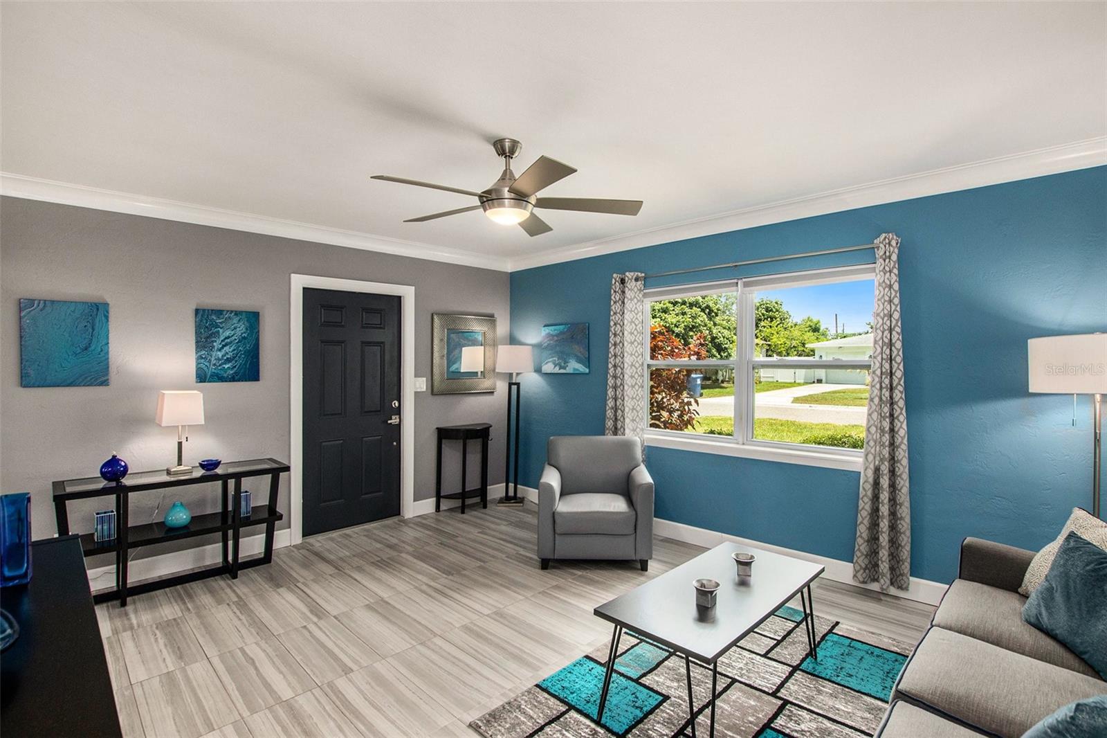 Enter into your  living room with cove molding and porcelain plank flooring.