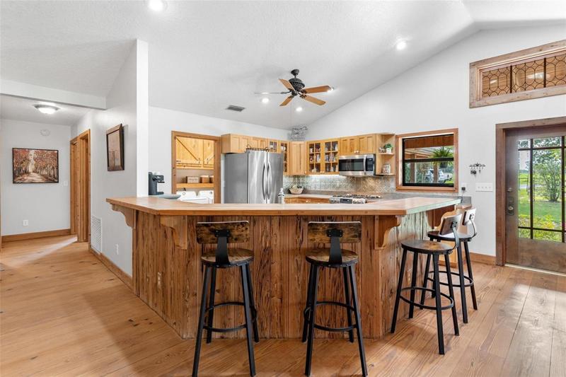 Kitchen Area with Door leading to Backyard Area