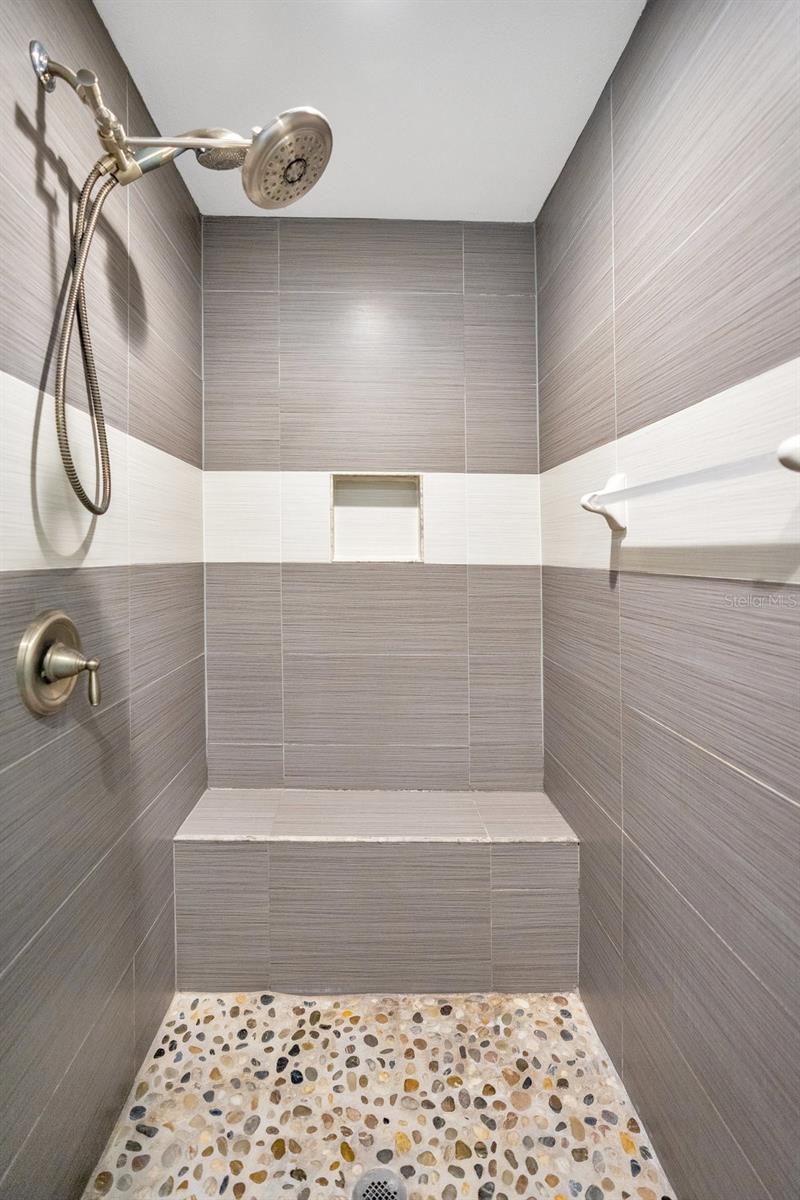 Primary bathroom has a walk-in-shower with handheld shower wand.