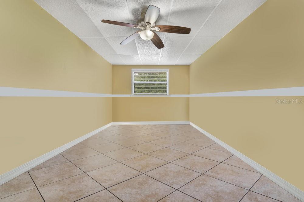 Opposite the laundry room is this bonus room with a closet and an exterior door going to the left side of the home.