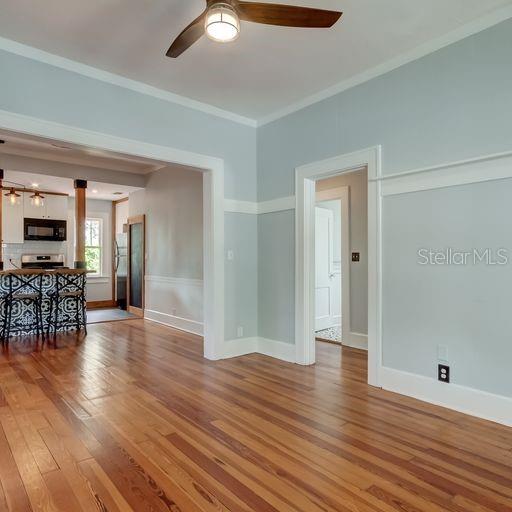 View of living room looking towards dining area, hallway, breakfast bar and kitchen.