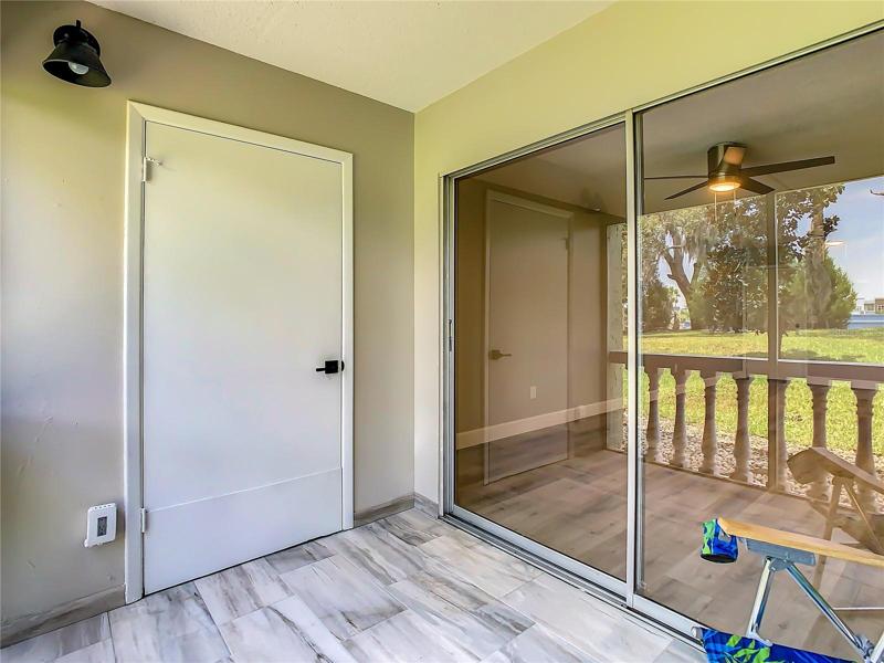 screened-in lanai adorned with complementary tile flooring. Savor a cup of coffee on breezy mornings or relax on tranquil afternoons or evenings as you unwind while relishing the picturesque views of the meticulously maintained grounds
