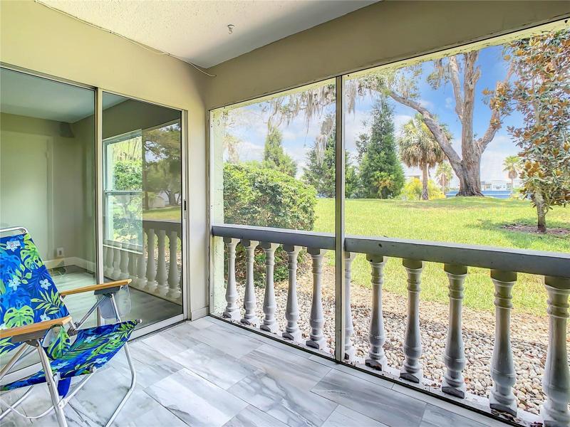 screened-in lanai adorned with complementary tile flooring. Savor a cup of coffee on breezy mornings or relax on tranquil afternoons or evenings as you unwind while relishing the picturesque views of the meticulously maintained grounds