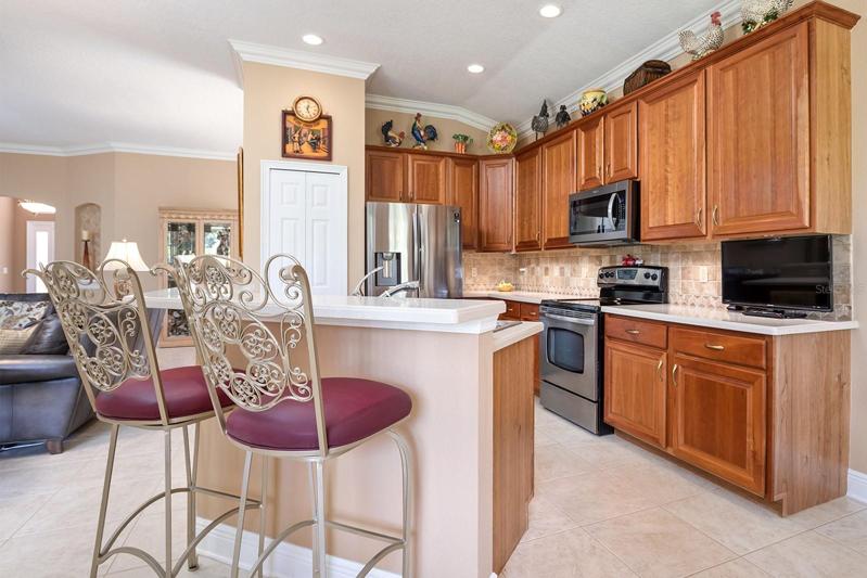 View of Wood cabinets and Bar in Kitchen