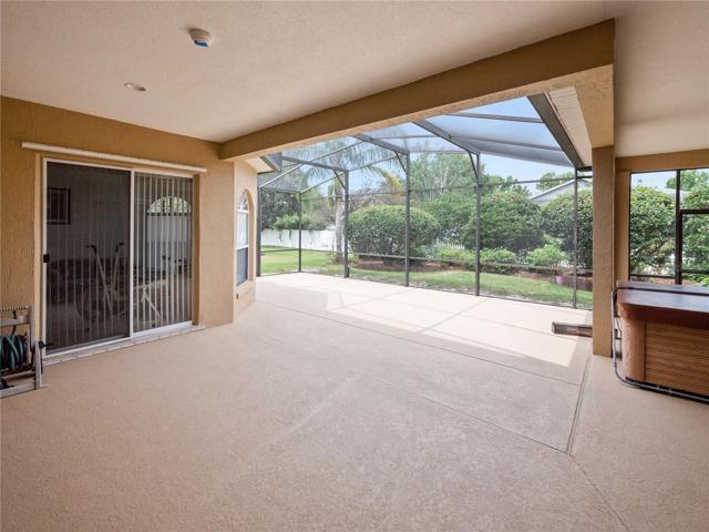 Gorgeous covered and screened back porch, with above-ground hot tub, included.
