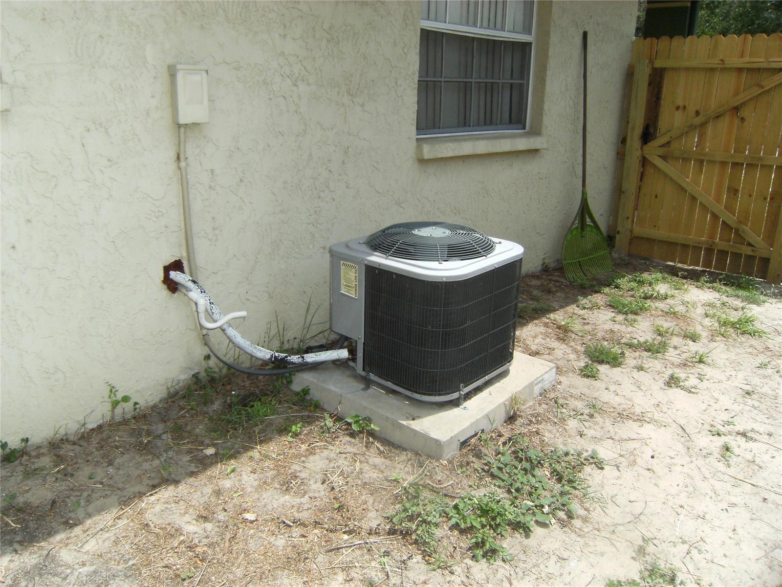 Side of Home with 3 year old AC