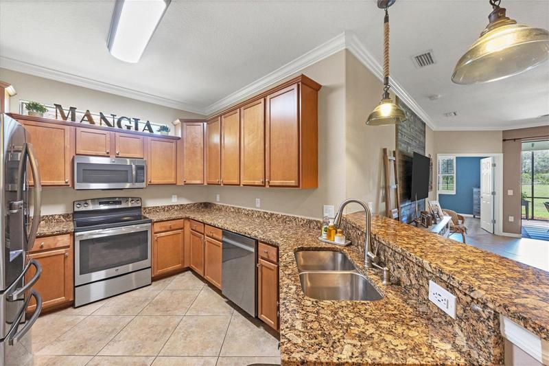 Kitchen with solid wood cabinets and stainless appliances