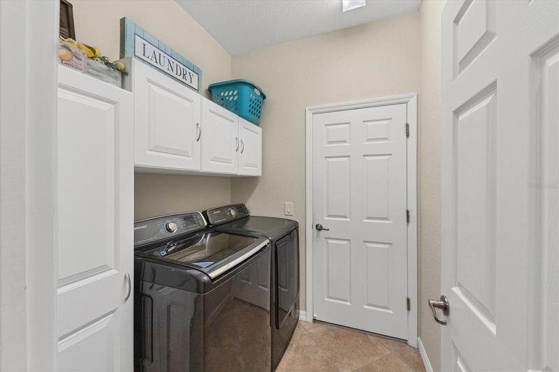 Laundry room with built in cabinets and Samsung washer and dryer
