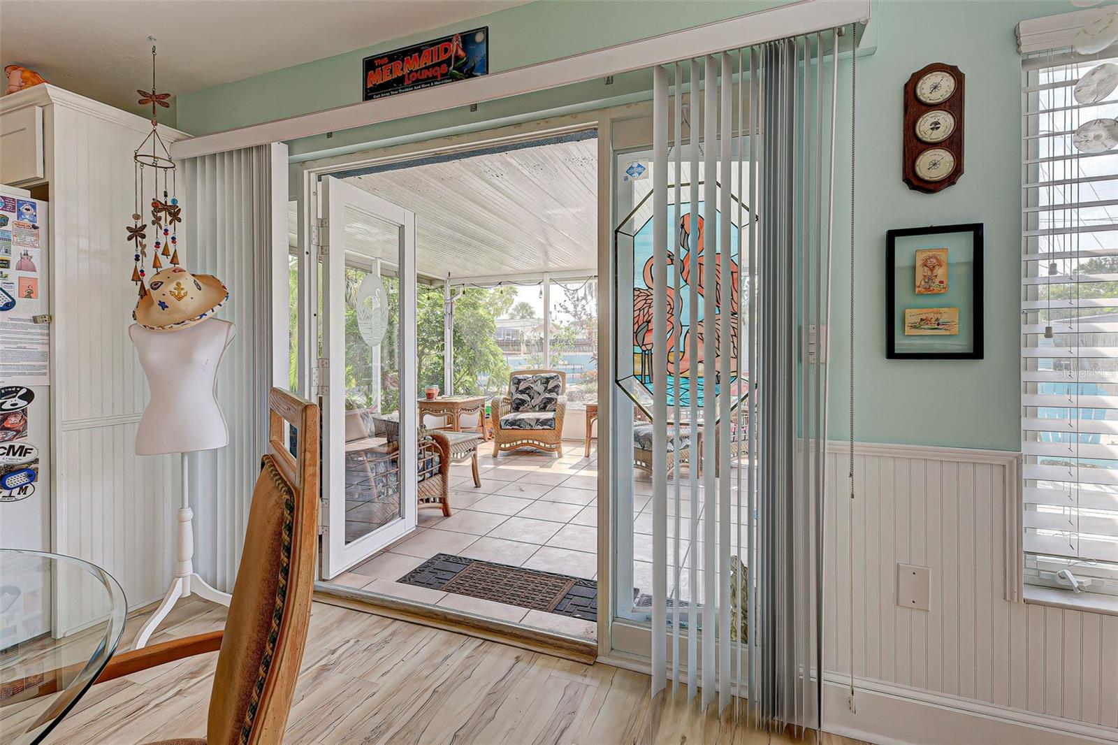 Etched glass patio doors to the covered sunroom