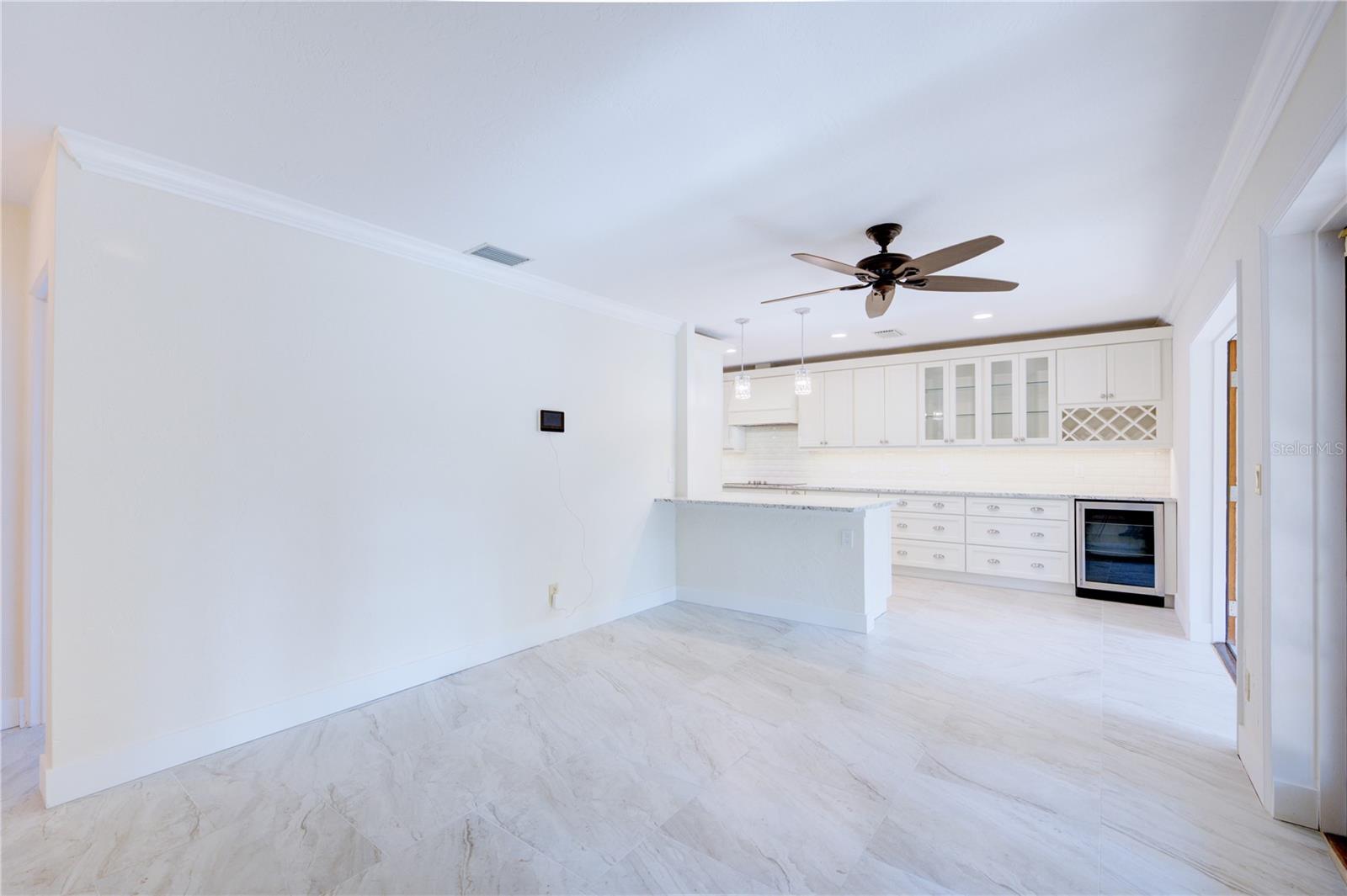 Open floor plan of Kitchen flowing into Living room area