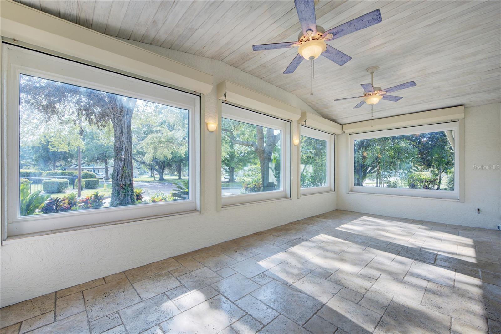 Great Room featuring large windows & travertine floors